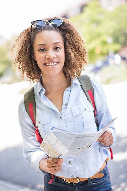istock African American tourist holding a map 485698994