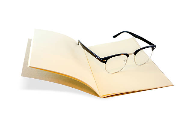 istock Brown notebook openned and eye glasses isolated on white backgro 485705248