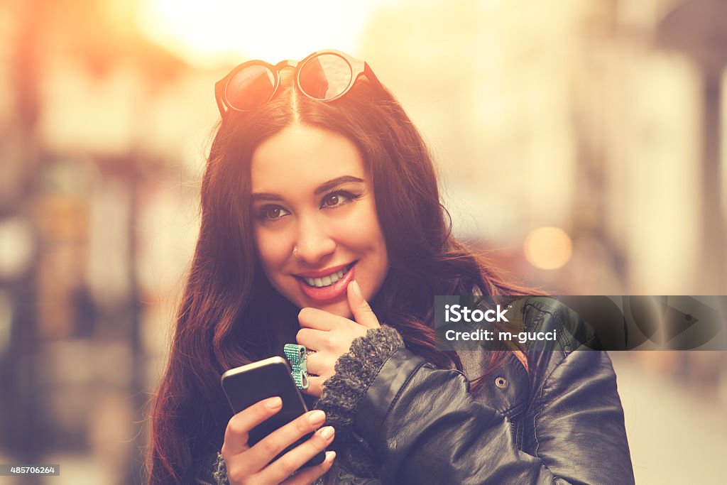 Young urban girl typing messages. Adult Stock Photo