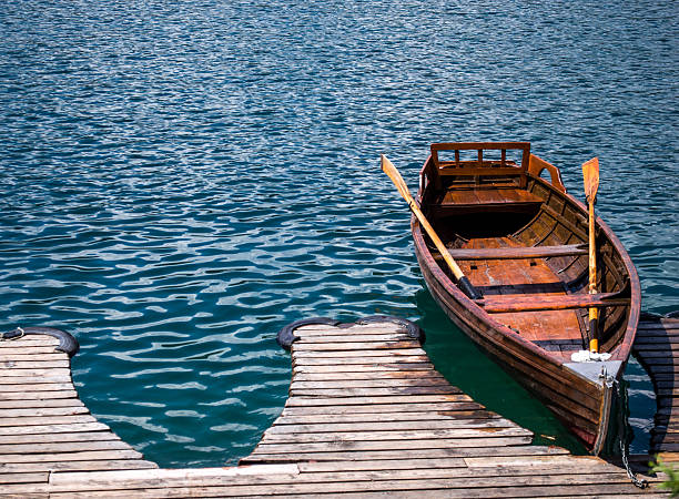 istock Classic Wooden Traditional Rowing Boat at a Jetty 485707712