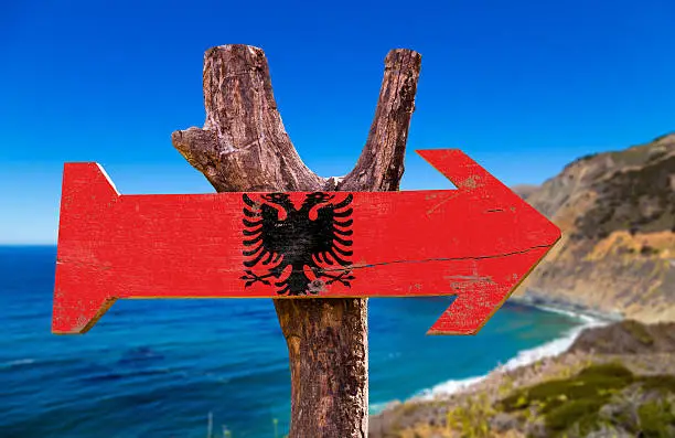 Albania Flag wooden sign with coast background