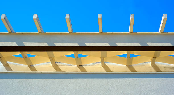 istock White pergola roof beans and blue sky mesh pattern 485713410