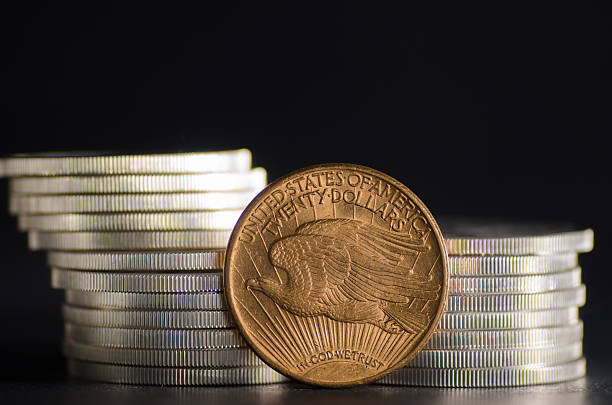 istock United States Gold Eagle Coin Saint-Gaudens infront Silver Coins 485714862