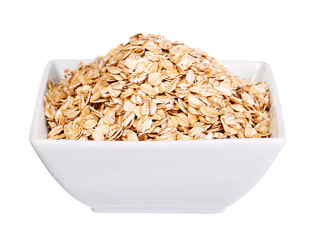 istock oatmeal flakes bowl isolated on white 485715082