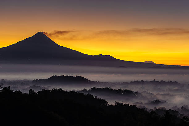 istock Colorful sunrise over Merapi volcano and Borobudur temple in mis 485715584
