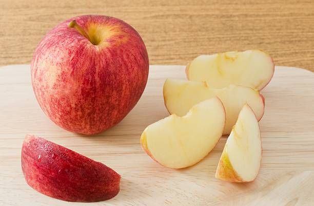 istock Ripe Red Apple on A Wooden Tray 485716242