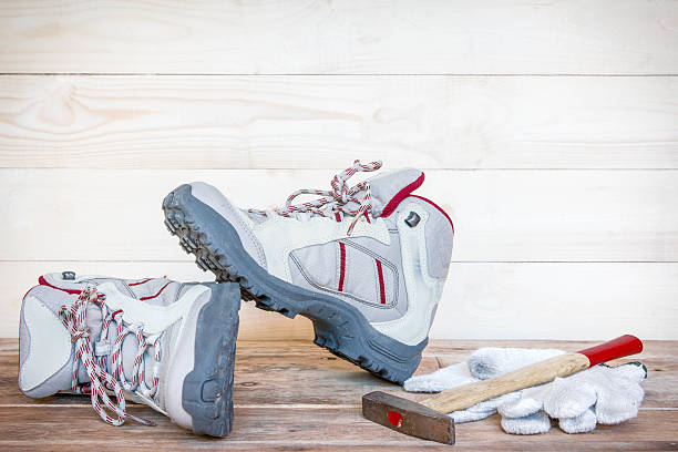 istock Pair of work boots with gloves and hammer on wood. 485717810