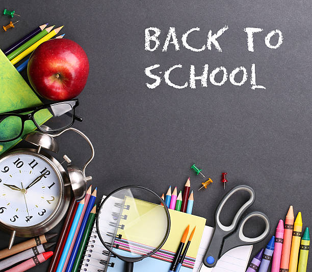 istock Books, apple, alarm and pencils on black board background and text 485722118