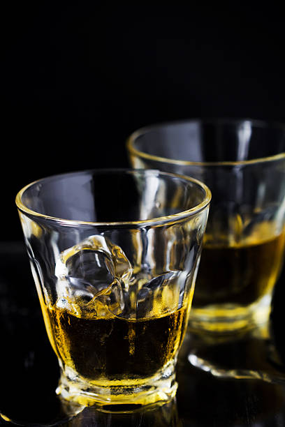 istock Two glasses of whiskey with ice cubes 485722372
