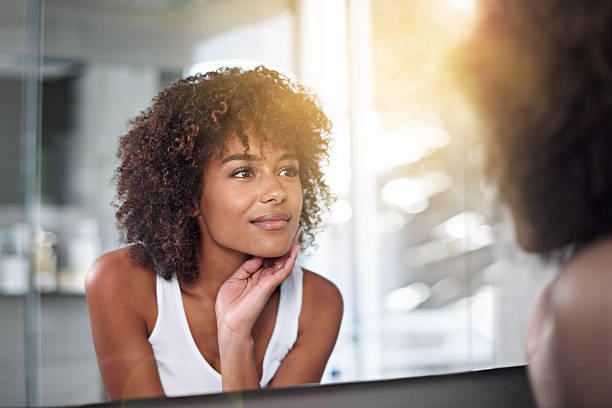 Her skin's as perfect as ever Cropped shot of a young woman examining her skin in the bathroomhttp://195.154.178.81/DATA/i_collage/pi/shoots/783545.jpg body care and beauty stock pictures, royalty-free photos & images