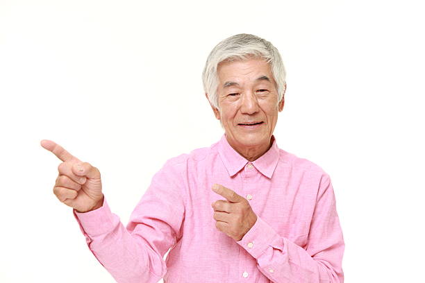 istock senior Japanese man presenting and showing something 485726492