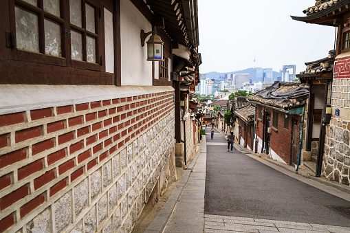 Seoul, South Korea - JUNE 15, 2015: Bukchon Hanok Village is a Korean traditional village, The traditional village is composed of lots of alleys, hanok and is preserved to show a 600-year-old urban environment. Now it is used as a traditional culture center and hanok restaurant, allowing visitors to experience the atmosphere of the Joseon Dynasty.