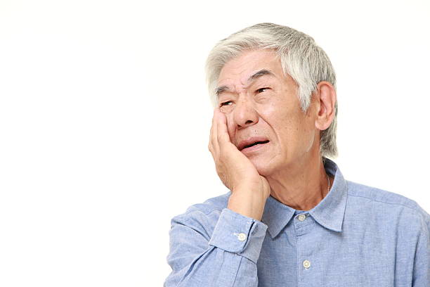 istock senior Japanese man suffers from toothache 485726768