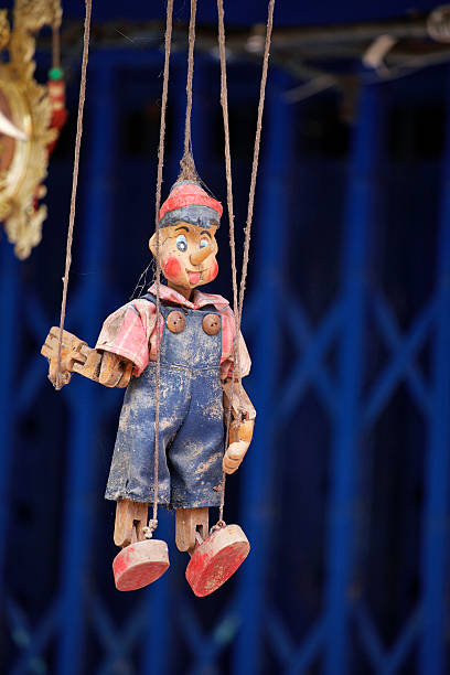 istock wooden doll hanging on blue background 485732787