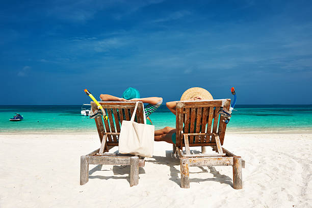 istock Couple in green relax on a beach at Maldives 485736113