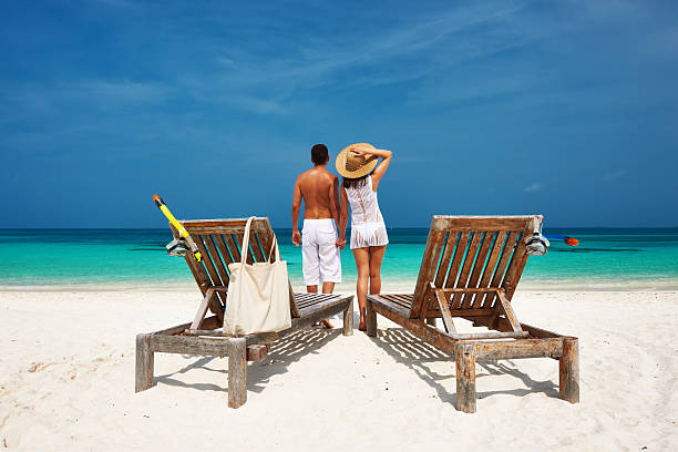 istock Couple in white on a beach at Maldives 485736427