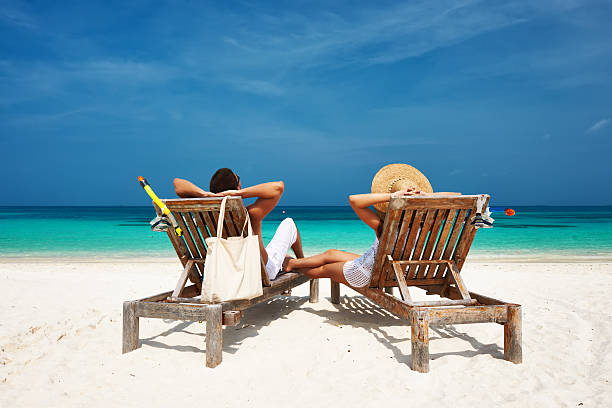 istock Couple in white relax on a beach at Maldives 485736429