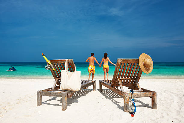 istock Couple in yellow running on a beach at Maldives 485736431