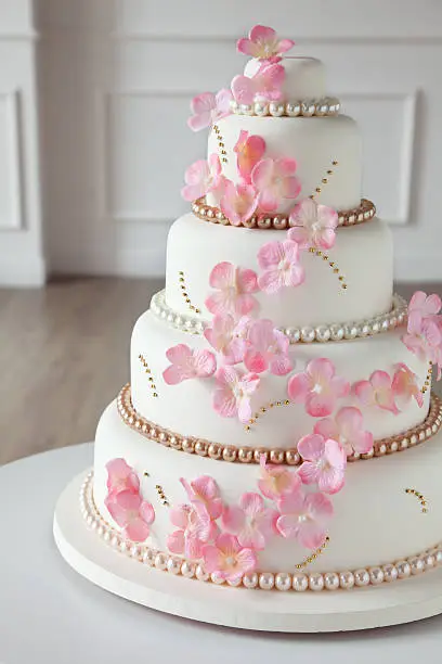 5 tier wedding cake decorated with cherry blossom