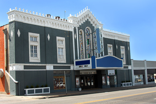 Wichita, Kansas landmark movie house has been remodeled and marqueed as a dinner theater.  Unique architecture has crosses and intricate eaves.