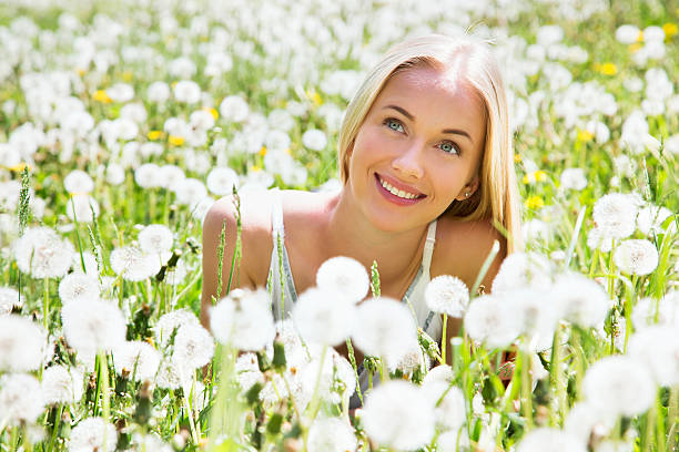 istock Beautiful young woman among dandelions 485747086