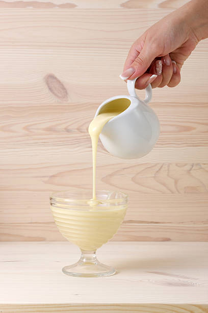 istock Pouring condensed milk in a bowl 485747996