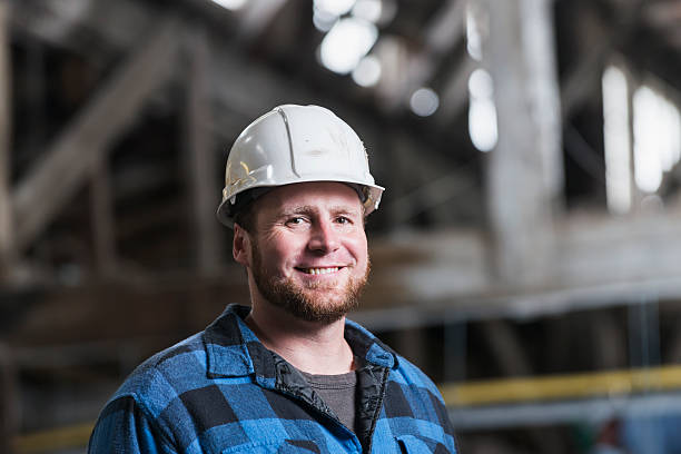 istock Man in industrial building wearing hardhat 485750942