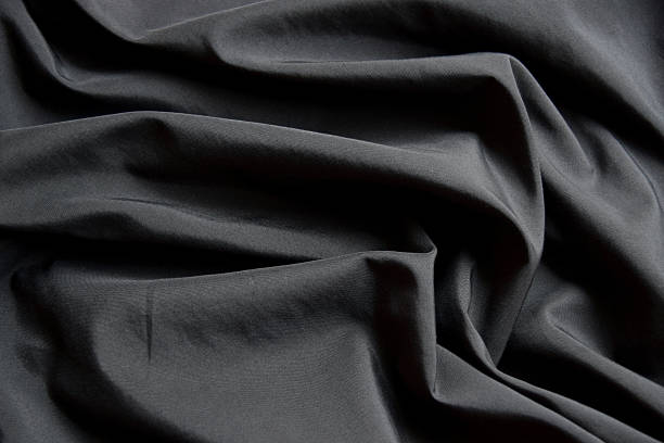 istock liquid wave or wavy folds of black cloth texture 485750976