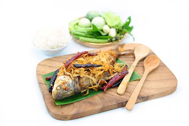 Photo of fried pickled fish (esarn food) on white background, Isolate