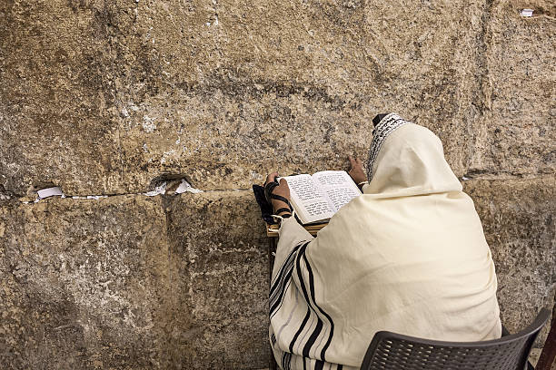 Prayer prayes at Western Wall in Jerusalem. stock photo