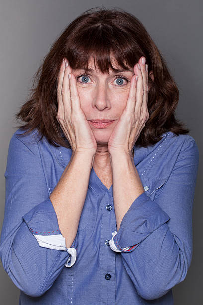 istock anxious attractive mature woman hiding her cheeks 485752938