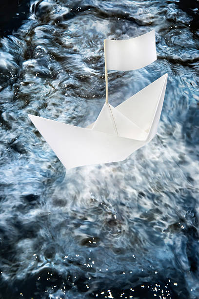 istock Paper boat at sea with flag 485753186