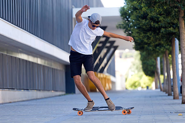istock Handsome young man skateboarding in the street. 485757786