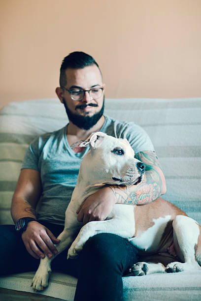 istock Man with tattoo embracing his dog. 485762298