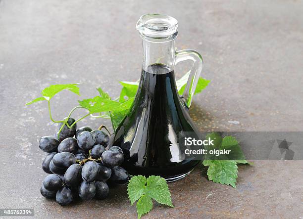 Balsamic Vinegar In A Glass Jug With Fresh Grapes Stock Photo - Download Image Now - Balsamic Vinegar, Vinegar, 2015
