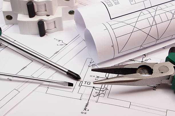 istock Work tools, electric fuse and rolls of diagrams on drawing 485765654