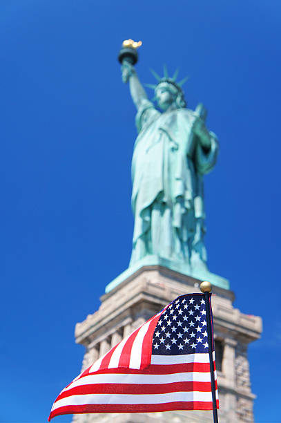 istock American Flag with blurred Statue of Liberty 485766942