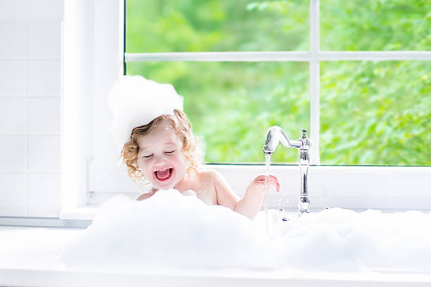 istock Baby girl taking bath with foam 485768466