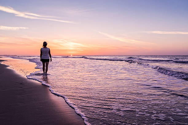 istock Greeting the morning sun at the beach. 485769224