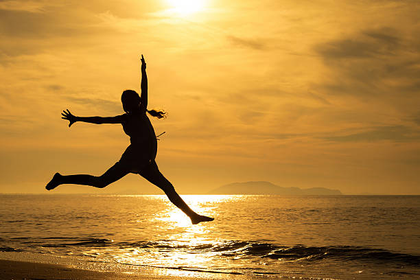 istock Happy girl jumping on the beach 485771878