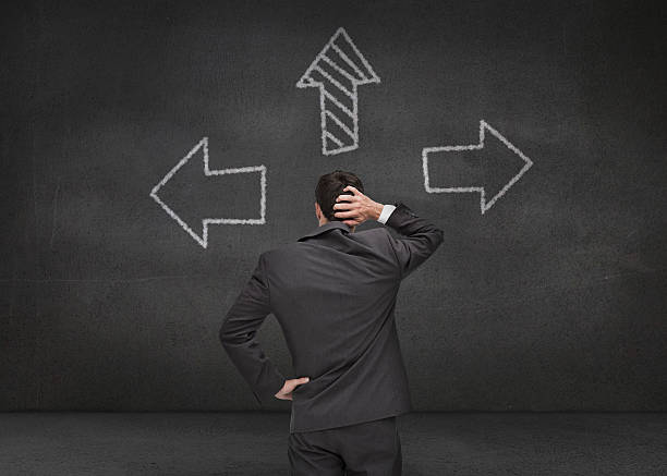 istock Thoughtful businessman looking at three arrows 485773361