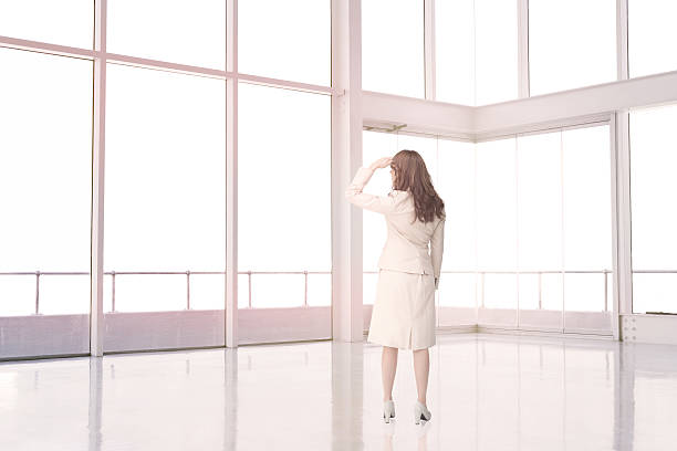istock Businesswoman standing in an empty room 485773731