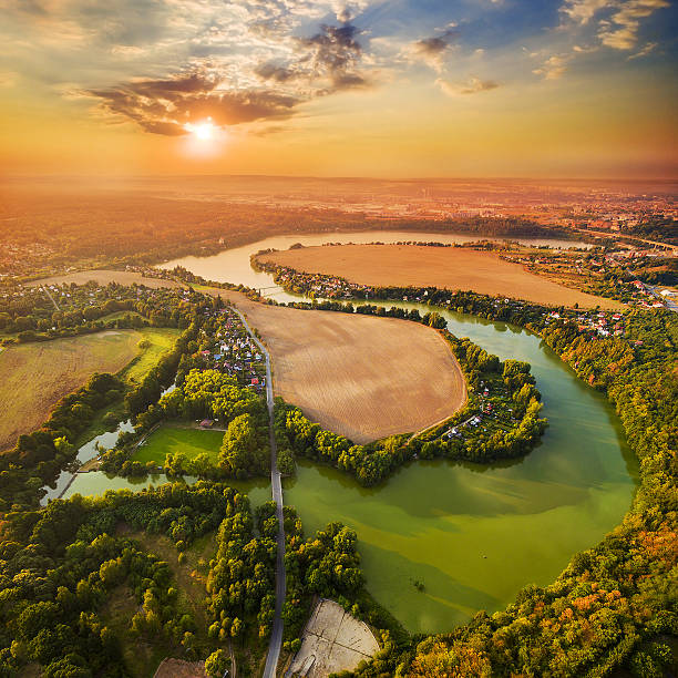 Sunset over lake. Beautiful sunset over Czech Valley Reservoir in The Litice suburban district of Pilsen.  Aerial view to scenic landscape in Czech Republic, Central Europe. HDR (warm filtered) photography. pilsen stock pictures, royalty-free photos & images