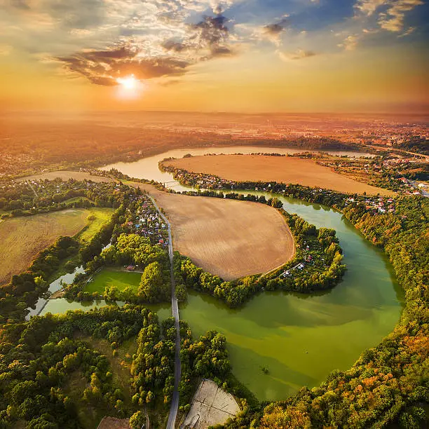 Beautiful sunset over Czech Valley Reservoir in The Litice suburban district of Pilsen.  Aerial view to scenic landscape in Czech Republic, Central Europe. HDR (warm filtered) photography.