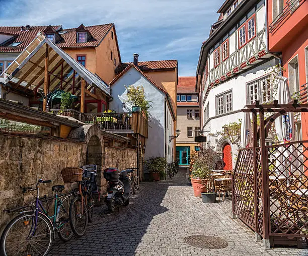 small alley with restaurants and bicycles on the wall. HDR. City Jena, Germany