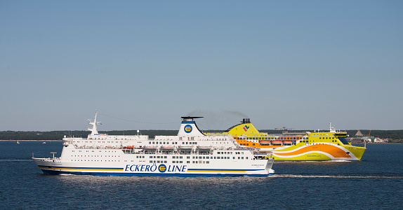 Helsinki, Finland - July 27, 2008: Two car ferries owned by Nordlandia and Tallink cross in the Baltic Sea just outside of the West Harbour in Helsinki, Finland.  These ships travel between Helsinki, the Baltic States, Sweden and other countries around the Baltic Sea.