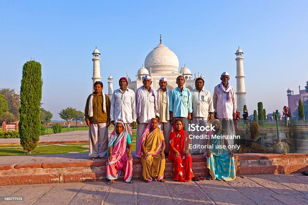 Thousands of tourists visit daily the Taj Mahal mausoleum Agra, India - November 16, 2011: local tourists pose for a photo at the Taj Mahal in Agra, India. 2,5 Mio. local tourists visit the UNESCO World heritage site yearly. Agra Stock Photo