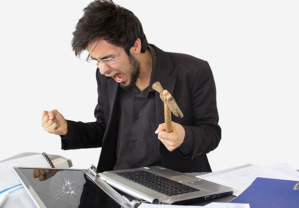 istock Young man screaming and breaking laptop 485778102
