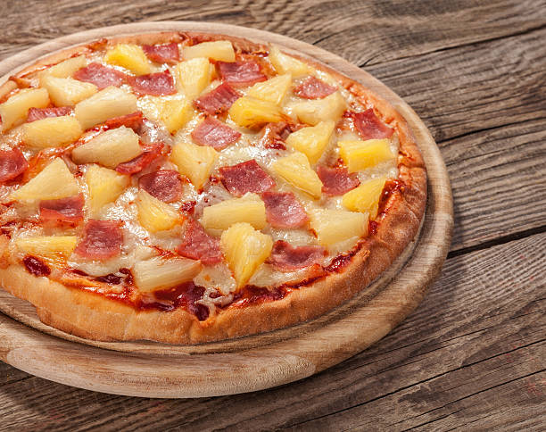 istock Hawaiian pizza on the old board 485778954