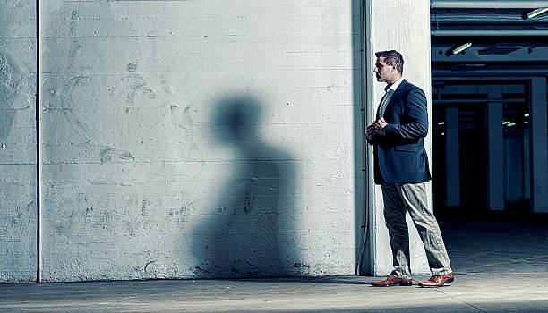 istock Businessman walks alone and cast a shadow 485779145